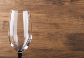 Glass of wine on wooden table. Horizontal studio shot. Copy space.