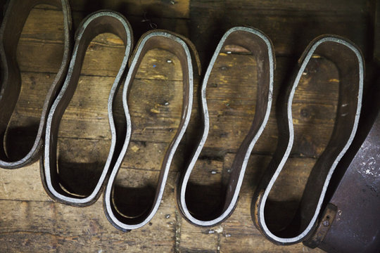 Metal shoe forms, template shapes for cutting leather components, in a shoemaker's workshop.