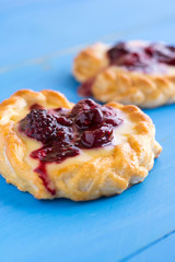 Vanilla Cream and Fruit Berry Puff Pastry Dessert on Blue Background
