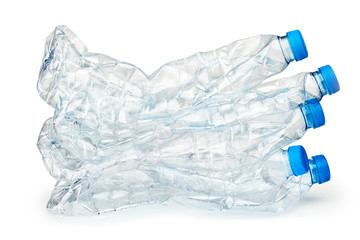 Stack of used plastic crushed bottles on white background