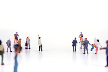 Minature people looking on white background