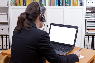 Online advice or education concept template: female professional with headset in front of a laptop...