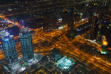 Fototapeta na wymiar Panoramic aerial view on downtown of Dubai, UAE with modern high skyscrapers at night. Architecture of future with bright lights and roads. United Arab Emirates famous tourist destination
