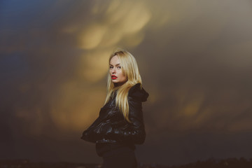 pretty blonde woman with red lips in leather jacket