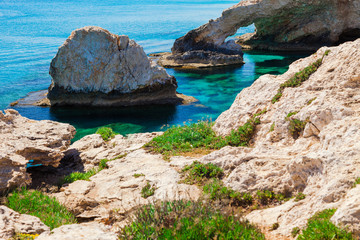 Beautiful natural rock arch near of Ayia Napa, Cavo Greco and Protaras on Cyprus island, Mediterranean Sea. Legendary bridge lovers. Amazing blue green sea and sunny day.