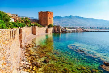 Peel and stick wall murals Turkey Kizil Kule tower in Alanya peninsula, Antalya district, Turkey, Asia. Famous tourist destination with high mountains. Part of ancient old Castle. Summer bright day