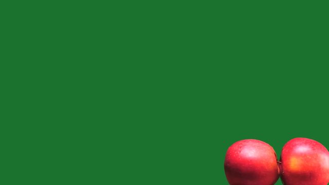 Abstract Sex imitation with apples on green background zooming