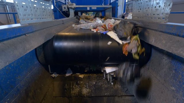 Garbage being sorted at waste processing plant.