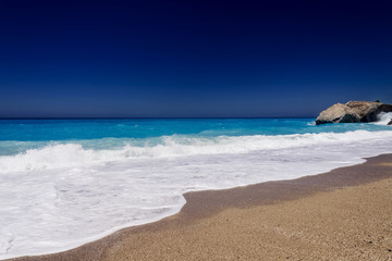 Beautiful sandy beach and wavy sea in summer