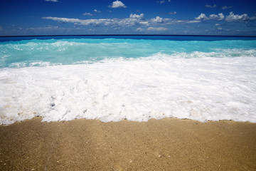 Beautiful sandy beach and wavy sea in summer