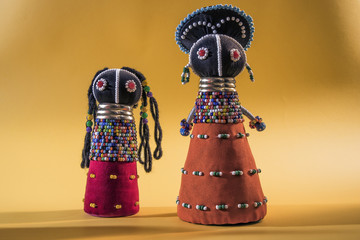African cloth dolls isolated on yellow background