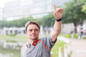 Content Sporty Man Greeting Someone in City