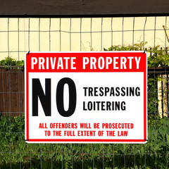 No trespassing sign in front of private property.