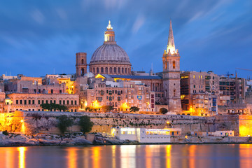 Naklejka na ściany i meble Valletta Skyline from Sliema with church of Our Lady of Mount Carmel and St. Paul's Anglican Pro-Cathedral during evening blue hour, Valletta, Capital city of Malta