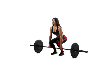 Fototapeta na wymiar Young athletic woman doing deadlift with a barbell on a white isolated background, standing full squat, legs at shoulder level