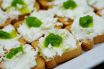 Goat cheese and garlic scape pesto mini toasts
