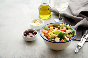 Pasta salad with vegetables and cheese. Concept of healthy eating, vegan food 
