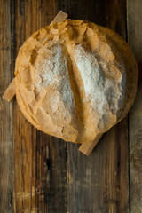 loaf of bread on wooden background, food closeup