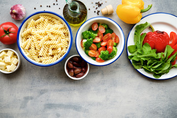 Ingredients pasta salad with vegetables and cheese. Concept of healthy eating, vegan food.Top view, food background

