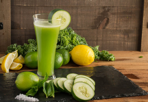 Refreshing Green Juice blend - Cool cucumbers, with a splash of lime and mint in a tall glass. Closeup, delicious image.