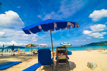 Chairs And Umbrella In Palm Sand Beach