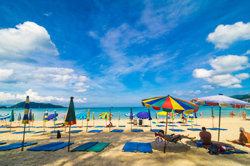 Fototapeta na wymiar Chairs And Umbrella In Palm Sand Beach