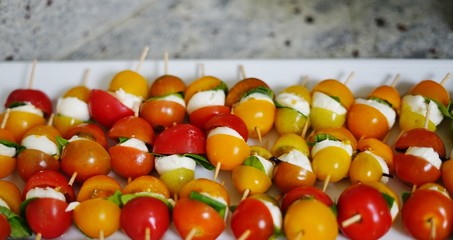 Mini skewers with fresh tomatoes, mozzarella cheese and basil