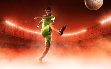 soccer player hits a ball on a soccer stadium on red steam background © TandemBranding