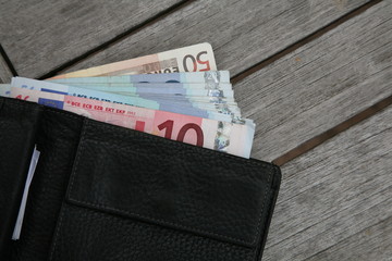 euros in black leather wallet