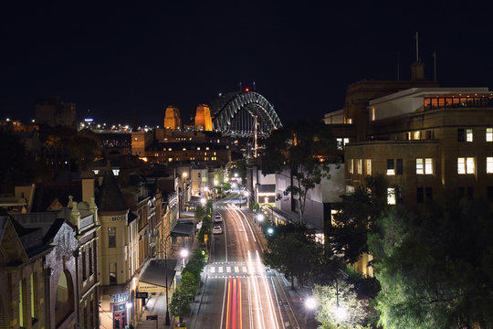 Sydney Harbour Bridge With Car Trails On The Roads Below At Night