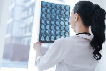 Involved medic holding mrt scan results at the roentgen cabinet
