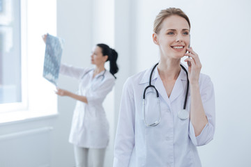 Delighted doctor having conversation at the medical lab