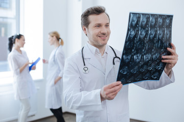 Experienced surgeon examining x ray photo at the medical lab