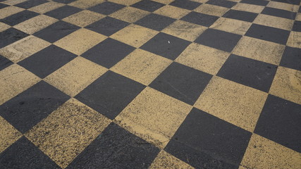 Top view of the asphalt of a car racing pit stop with painted signs and marks.