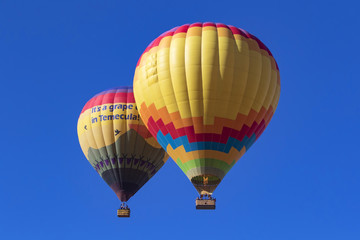 Balloons floating together over Southern California winery and vineyards