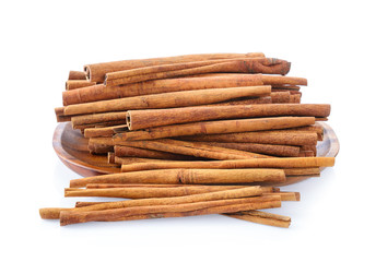 Cinnamon in plate on white background