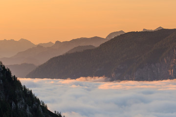 Orange sunrise above clouds