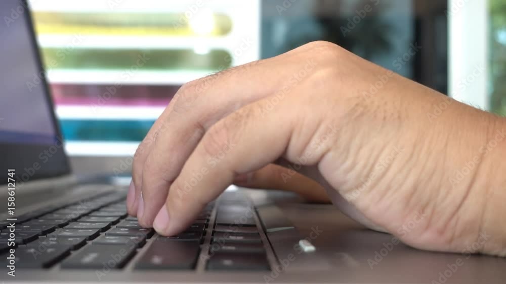 Poster Man hands typing on a laptop computer keyboard