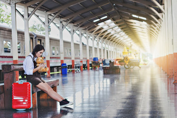 Traveling with a girl train with a brown bear