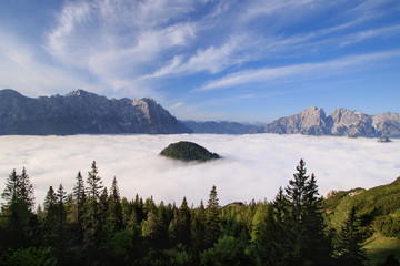 Sunrise above sea of clouds