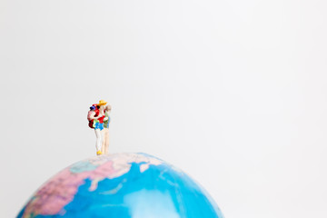 Miniature people figure  standing on the globe world map