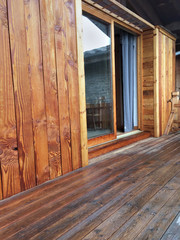 bardage et terrasse en bois d'un chalet  avec baie vitrée