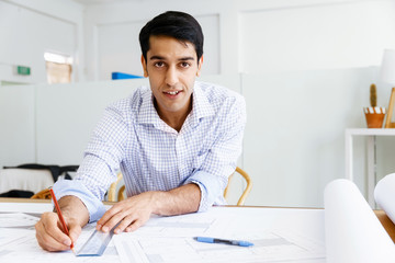 Young man architect in office