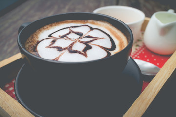 hot coffee with foam milk art in afternoon break