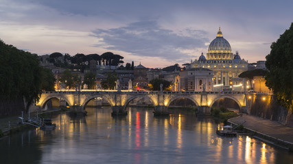 St. Peter's Basilica and Ponte Sant angelo at dusk in vatican city, Rome, Italy.