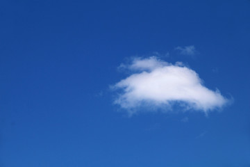 A small white cloud on a blue sky