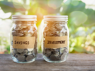Full of coins in glass jar with savings and investment tap.