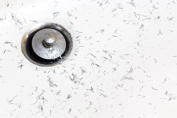 Pieces of mustache and beard in washbasin