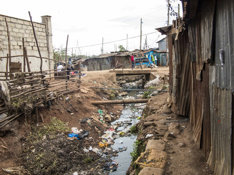 Open sewer and tin shacks in a slum in Africa