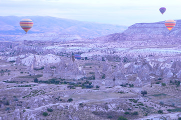 Hot air balloon flying over rock landscape at Cappadocia Turkey